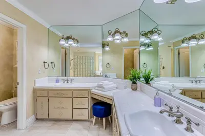 a bathroom with two sinks and a large mirror at Billiards and Private Pool Bright Clovis Home! in Clovis