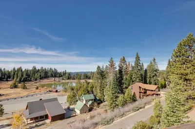an aerial view of a resort with a river and trees at Strawberry Townhouse Walk to Leland Snowplay! in Strawberry