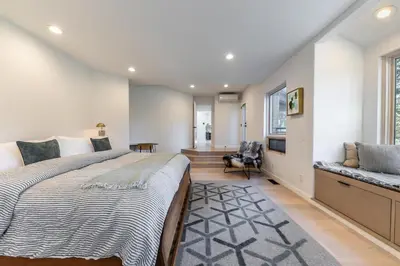 a bedroom with a large bed and a window at Open Air at Palisades - 3 BR, Brand New Construction - Wrap-Around Deck w Hot Tub in Olympic Valley
