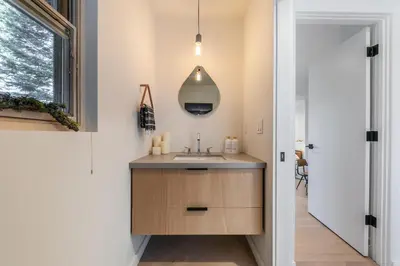 a bathroom with a sink and a mirror at Open Air at Palisades - 3 BR, Brand New Construction - Wrap-Around Deck w Hot Tub in Olympic Valley