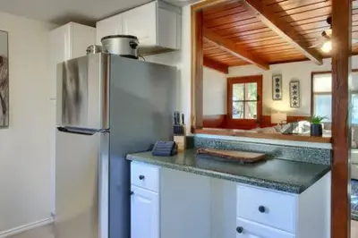 a kitchen with a refrigerator and a counter top at Blue Door Cottage 12 miles to Yosemite Bbq in Oakhurst
