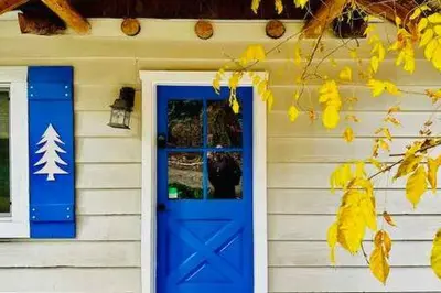 a house with a blue door and a window at Blue Door Cottage 12 miles to Yosemite Bbq in Oakhurst