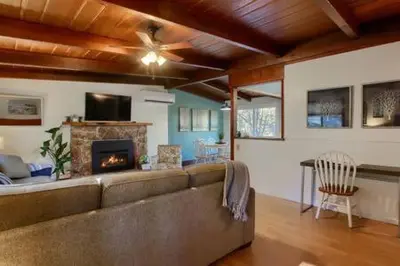 a living room with a couch and a fireplace at Blue Door Cottage 12 miles to Yosemite Bbq in Oakhurst