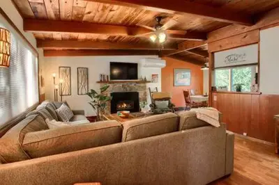 a living room with a large couch and a fireplace at Orange Door Electric Fireplace bbq in Oakhurst
