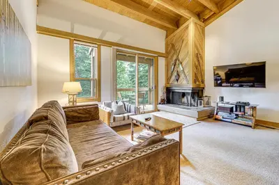 a living room with a couch and a fireplace at Less Than 1 Mi to North Star Resort Condo with Balcony in Truckee