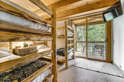 a room with three bunk beds and a balcony at Less Than 1 Mi to North Star Resort Condo with Balcony in Truckee