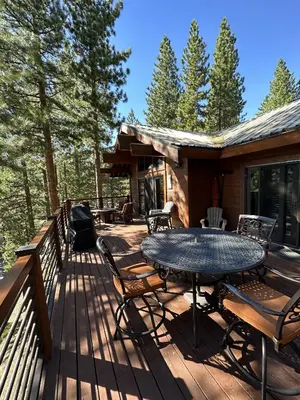 a deck with a table and chairs on a cabin at Luxury 4 bedroom 4 5 bath luxury home that sleeps 10 in Incline Village