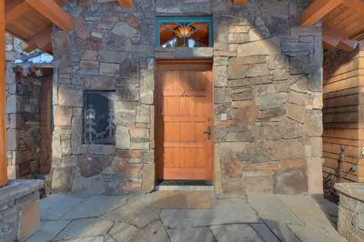 an entrance to a stone building with a wooden door at Sundance Lodge -Mountain Home w Views of Palisades - Ski Shuttle, Pets okay! in Olympic Valley