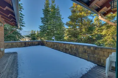a snow covered backyard with a fence and trees at Sundance Lodge -Mountain Home w Views of Palisades - Ski Shuttle, Pets okay! in Olympic Valley