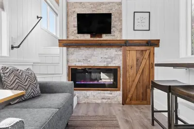 a living room with a couch and a fireplace at Tiny Home | Lewis Ranch 1 in Lindsay