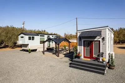 a tiny house with a gazebo in a yard at Tiny Home | Lewis Ranch 1 in Lindsay