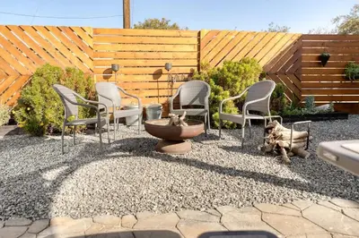 a group of chairs and a fountain in a yard at Tiny Home | Lewis Ranch 1 in Lindsay