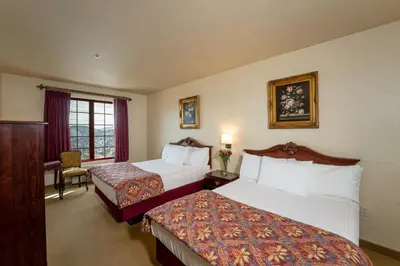 a hotel room with two beds and a window at Silverland Inn in Virginia City