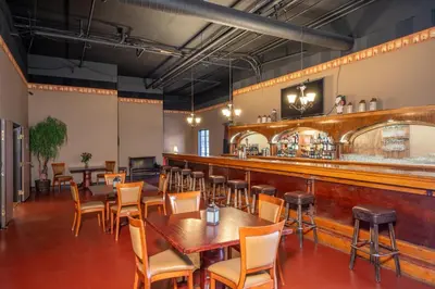 a restaurant with tables and chairs and a bar at Silverland Inn in Virginia City