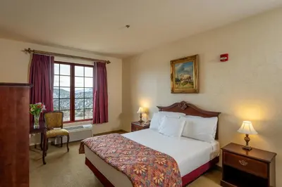 a hotel room with a bed and a window at Silverland Inn in Virginia City