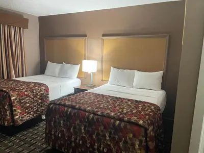 a hotel room with two beds and a lamp at Dream Inn in Tonopah