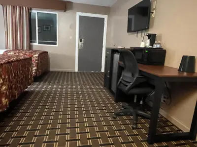 a hotel room with a desk and a bed at Dream Inn in Tonopah