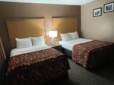 a hotel room with two beds and a lamp at Dream Inn in Tonopah