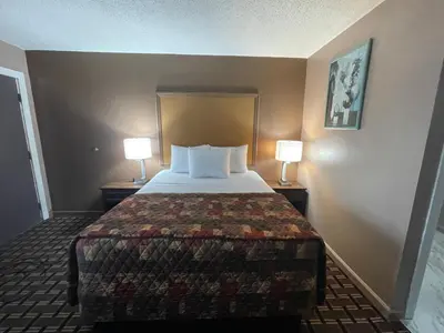 a bed in a hotel room with two lamps at Dream Inn in Tonopah