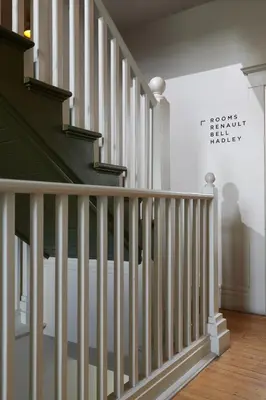a staircase with white railings in a house at The Jesse Hotel & Bar in Reno