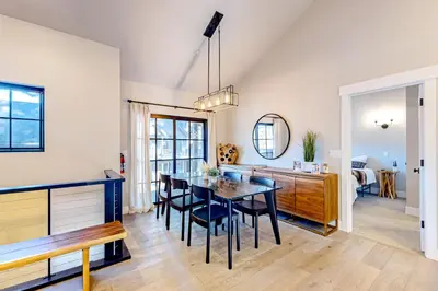 a dining room and living room with a table and chairs at Twilight's Rest in Zephyr Cove