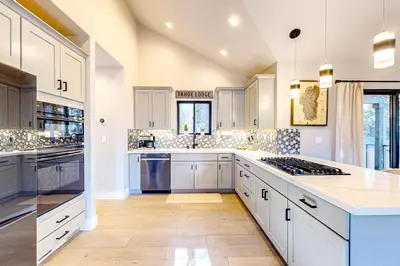 a kitchen with white cabinets and a stove top oven at Twilight's Rest in Zephyr Cove