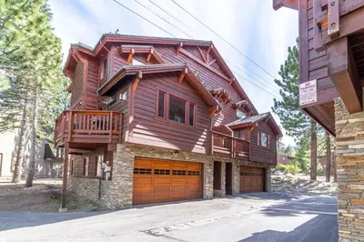 a large wooden house with a garage at Luxury Townhome, Walk to the Village, Wifi, Private Spa & Garage in Mammoth Lakes