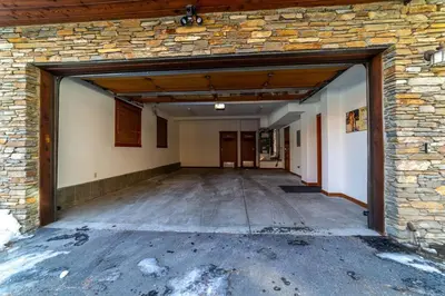 an empty garage with a stone wall at Luxury Townhome, Walk to the Village, Wifi, Private Spa & Garage in Mammoth Lakes