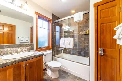 a bathroom with a toilet and a tub and a sink at Luxury Townhome, Walk to the Village, Wifi, Private Spa & Garage in Mammoth Lakes