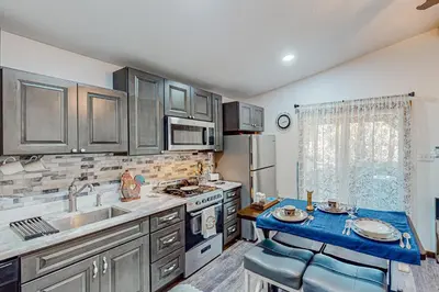 a kitchen with a sink and a stove at 1BR Dog-Friendly Lakefront Cabin with Canoes in Twain Harte