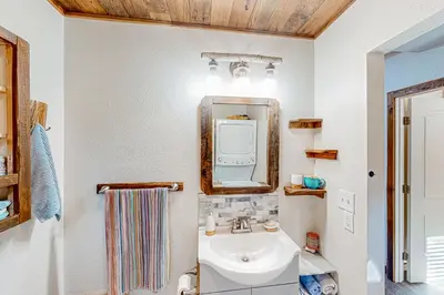 a bathroom with a sink and a mirror at 1BR Dog-Friendly Lakefront Cabin with Canoes in Twain Harte