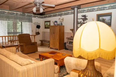 a living room with a couch and a table at A-Frame Cabin in The Sequoias in Wofford Heights