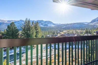 a balcony with a view of the mountains at Juniper Springs Lodge #412 - Luxury Ski in Ski out! 2 Bedroom in Mammoth Lakes