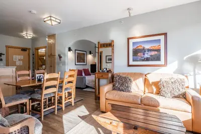 a living room with a couch and a table at Juniper Springs Lodge #412 - Luxury Ski in Ski out! 2 Bedroom in Mammoth Lakes