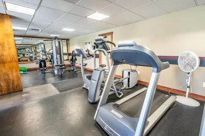 a gym with tread machines and a treadmill at Juniper Springs Lodge #412 - Luxury Ski in Ski out! 2 Bedroom in Mammoth Lakes