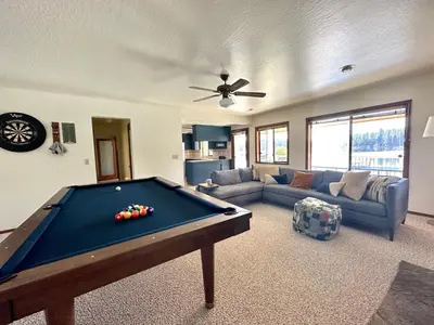 a living room with a pool table and a couch at Luxury Yosemite Lake House in Groveland