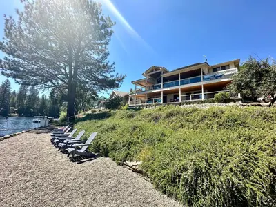 a row of chairs sitting on a hill next to a building at Luxury Yosemite Lake House in Groveland
