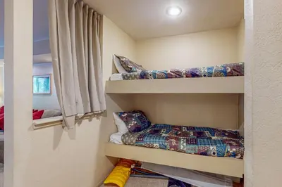a room with two bunk beds and a window at Horizons 4 131 in Mammoth Lakes