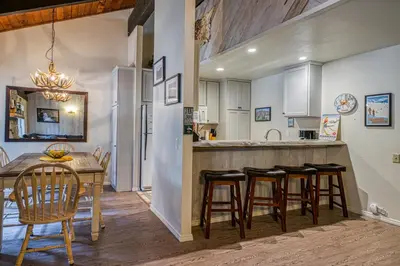 a kitchen and dining room with a table and chairs at Horizons 4 138 in Mammoth Lakes