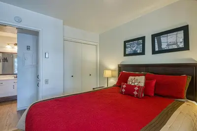 a bedroom with a red bed with a red blanket at Horizons 4 138 in Mammoth Lakes