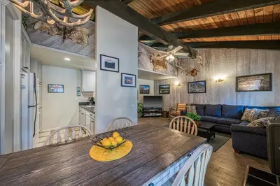 a kitchen and living room with a table and a couch at Horizons 4 138 in Mammoth Lakes
