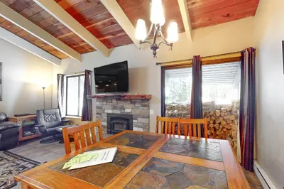 a dining room with a table and a fireplace at Horizons 4 158 in Mammoth Lakes