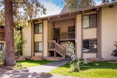 a house with a balcony and a tree at Horizons 4 158 in Mammoth Lakes