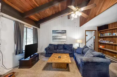 a living room with a blue couch and a table at Horizons 4 160 in Mammoth Lakes