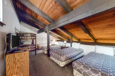 a room with two beds and a flat screen tv at Horizons 4 160 in Mammoth Lakes