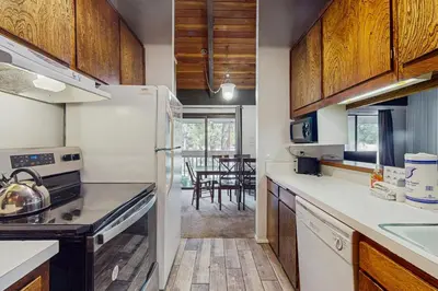 a kitchen with a refrigerator and a dining room at Horizons 4 160 in Mammoth Lakes