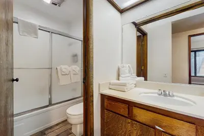 a bathroom with a sink and a toilet and a mirror at Horizons 4 160 in Mammoth Lakes