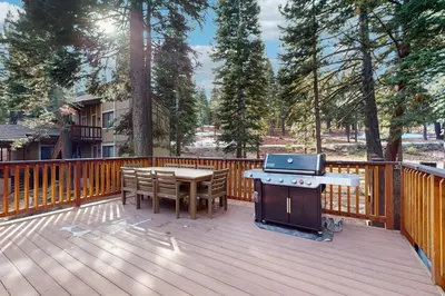 a deck with a ping pong table and a grill at Gold Bear in Truckee