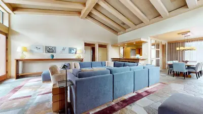 a living room with a blue couch and a table at Obsidian #1 home in Mammoth Lakes