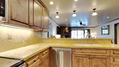 a large kitchen with wooden cabinets and a sink at 1849 Condos 103 home in Mammoth Lakes
